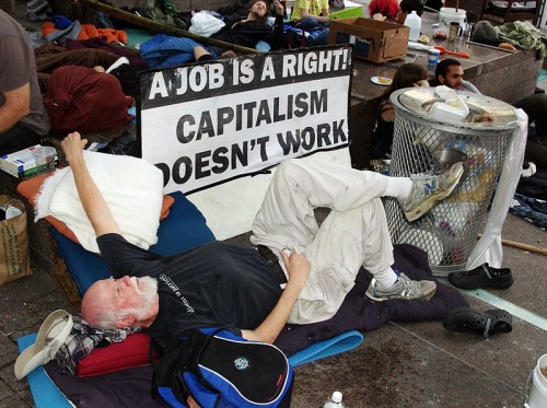 A man at the protest event Occupy Wall Street critiquing Capitalism in the context of the right to have a job.