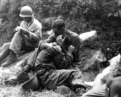 G.I. comforting a grieving infantryman, Korean War. 